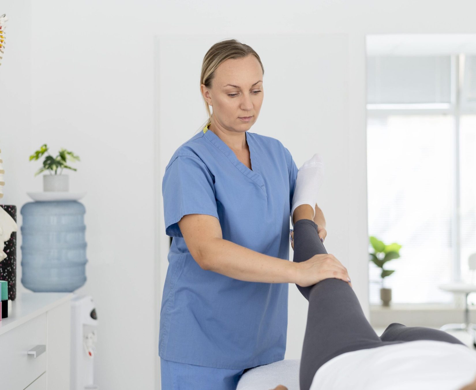 physiotherapist-helping-young-female-patient (1)-min